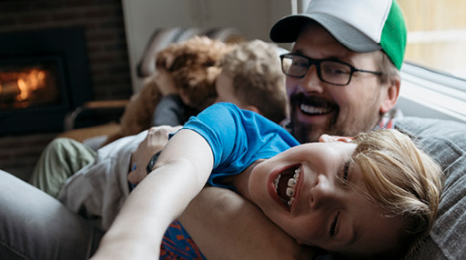 man on sofa with children