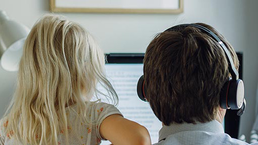man and girl looking at screen